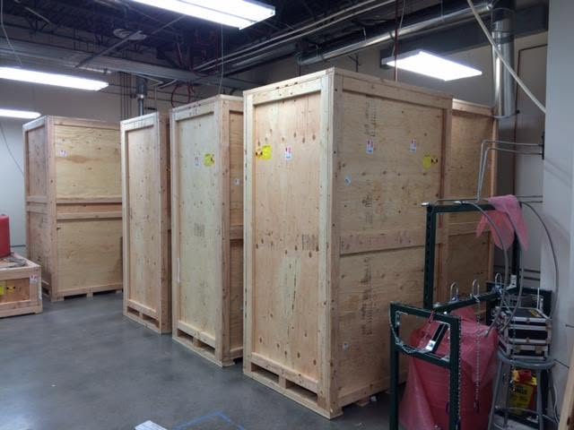 Multiple finished custom wood crates inside a commercial facility